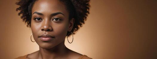 African American 3035 Years Woman Isolated On A Amber Background With Copy Space. photo