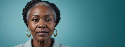 A 50S Adult African American Woman Isolated On A Aquamarine Background With Copy Space. photo