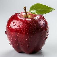 Red apple with leaf and water drops on white background photo