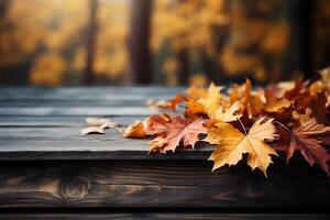 Autumn maple leaves on wooden table, falling leaves natural background photo