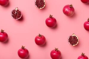 Pattern of fresh pomegranates on pink background, top view photo