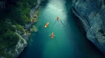 Aerial View of Kayakers Paddling Along a Beautiful Mountain River. . photo