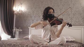 beautiful girl in mask playing the violin screwed up and started laughing video