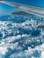 View of a steep rocky snow-capped mountain range from an airplane window photo