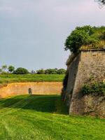 Park with green hills and historical architecture at the Petrovaradin Fortress photo