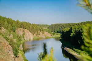 Tranquil River in Verdant Summer Woodlands photo