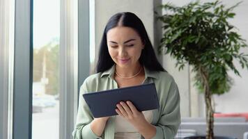 Young business girl working with tablet in coffee shop cafe video