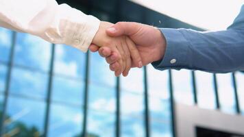 Handshake of business partners on the background of an office building video