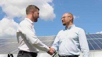 Two workers check the installed solar panels. Green electricity concept video