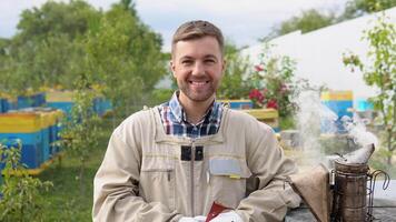 Beekeeper at Work. Bee keeper lifting shelf out of hive. The beekeeper saves the bees video