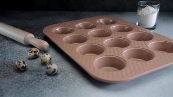 Quail Eggs Beside Muffin Baking Tray and Rolling Pin on Kitchen Counter video