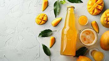 Bottle Of Mango Beer Amidst Slices of Mango On Bright White Background With Copy Space. photo