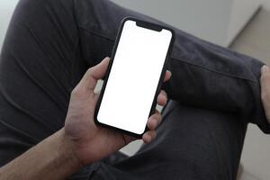 Hand holding smartphone in office, using phone photo