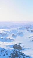 A breathtaking snowy mountain range seen from above during a plane journey video