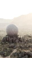 A massive surveillance antenna standing alone in the vast desert landscape video
