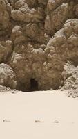 A sandy beach covered in lots of rocks video