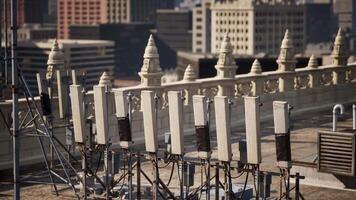 A stunning view of a row of white pillars atop a building amidst the metropolis video