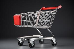 A shopping cart with a distinctive red handle parked on a gray background. photo