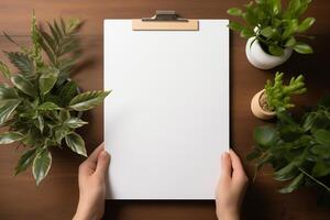 A person holding a clipboard with a blank sheet of paper on it, ready to jot down notes or instructions. photo