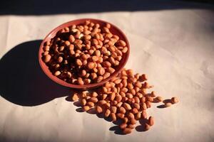 Peanuts are usually made into sauces or peanut butter, close up and selective focus, isolated on white background. photo