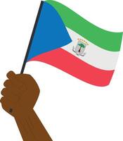 Hand holding and raising the national flag of Equatorial Guinea vector