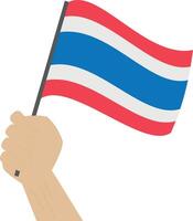 Hand holding and raising the national flag of Thailand vector