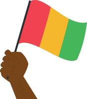 Hand holding and raising the national flag of Guinea vector