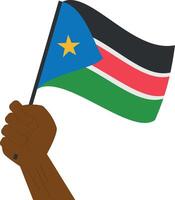 Hand holding and raising the national flag of South Sudan vector