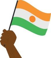 Hand holding and raising the national flag of Niger vector