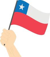 Hand holding and raising the national flag of Chile vector