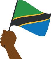 Hand holding and raising the national flag of Tanzania vector