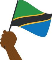 Hand holding and raising the national flag of Tanzania vector