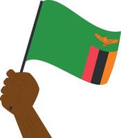 Hand holding and raising the national flag of Zambia vector