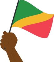 Hand holding and raising the national flag of Republic of Congo vector