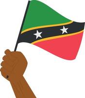 Hand holding and raising the national flag of Saint Kitts and Nevis vector