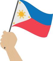 Hand holding and raising the national flag of Philippines vector