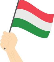 Hand holding and raising the national flag of Hungary vector