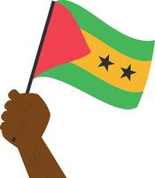 Hand holding and raising the national flag of Sao Tome and Principe vector