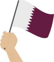 Hand holding and raising the national flag of Qatar vector
