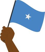 Hand holding and raising the national flag of Somalia vector