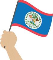 Hand holding and raising the national flag of Belize vector