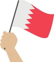 Hand holding and raising the national flag of Bahrain vector