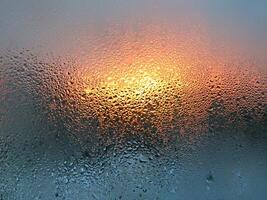 Water drops and sunlight on glass photo