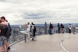 Frankfurt, Germany, August 08, 2023. Excursion. People look at the city from a tall building. Many people are on the observation deck of a high-rise building and admire the beauty of the city. photo
