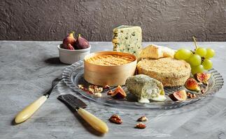 Assortment of French cheese with fruits and nuts photo