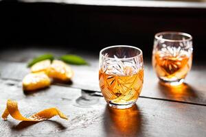 Two glasses with tangerine liqueur photo