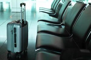 Suitcase in an empty airport departure lounge photo