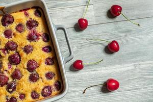 Clafoutis cherry pie in a baking dish photo