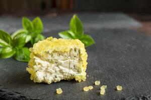 Goat cheese with pineapple on a slate photo