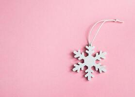 White snowflake on a pink background photo